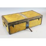 A 1920's Louis Vuitton travelling trunk, with orange yellow covering and brass studded brown leather