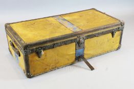 A 1920's Louis Vuitton travelling trunk, with orange yellow covering and brass studded brown leather