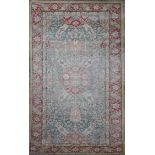 A Turkish blue ground rug, with central foliate medallion in a field of scrolling foliage and