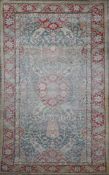 A Turkish blue ground rug, with central foliate medallion in a field of scrolling foliage and