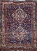 A Qashgai blue ground rug, with two central hooked diamond shaped motifs in a geometric field, 7ft