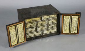 A late 19th century 17th century style German iron bound oak strong box, with two doors opening to