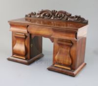 An early Victorian mahogany novelty tea caddy in the form of a twin pedestal sideboard, with three