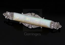 A 1940's/1950's white gold?, white opal and diamond set bar brooch, the opal stone measuring 31mm in