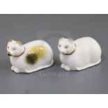 Two Rockingham porcelain figures of a recumbent cat, c.1830, in white and tortoiseshell markings,