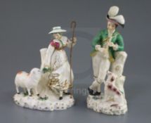 A pair of Rockingham porcelain groups of a shepherd and shepherdess, c.1830, each standing by a tree