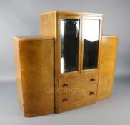 An Art Deco birds eye maple display cabinet and similar dining table, the table with rectangular top