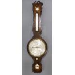 C.Heseltine, Bedford Row. A Regency mahogany wheel barometer with silvered dials 44in.