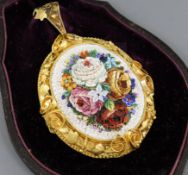 A Victorian yellow metal mounted micro-mosaic oval pendant depicting roses and mixed flowers, with