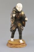 A Japanese lacquer and ivory okimono of a man, Taisho period, 1920s, his robes decorated in gilt and