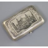 A late 19th century Russian 84 zolotnik silver and niello cigarette case, decorated with view of