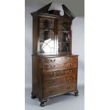 A George III mahogany secretaire bookcase, with broken arch cornice and two astragal glazed doors