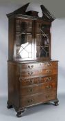 A George III mahogany secretaire bookcase, with broken arch cornice and two astragal glazed doors