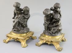 After Paul Emile Machault (1800-1866). A pair of 19th century bronze groups of putti playing dice