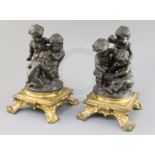 After Paul Emile Machault (1800-1866). A pair of 19th century bronze groups of putti playing dice