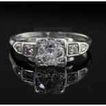 A 1930's/1940's platinum and single stone diamond ring, with diamond set shoulders the centre
