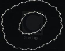 An 18ct white gold and diamond set spectacle necklace and matching bracelet, in original Turkish box