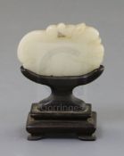 A Chinese white jade 'lion-dog' plaque, 18th century, the stone of good even tone with tiny