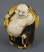 A Japanese ivory okimono netsuke of Hotei, early 20th century, standing and holding a rosary and his