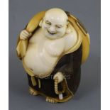 A Japanese ivory okimono netsuke of Hotei, early 20th century, standing and holding a rosary and his