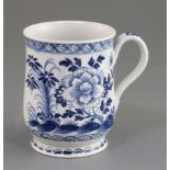 A Bow bell-shaped blue and white mug, c.1770 painted with flowers rockwork and insects, unmarked, H.
