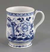 A Bow bell-shaped blue and white mug, c.1770 painted with flowers rockwork and insects, unmarked, H.