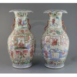 A pair of Chinese famille rose vases, 19th century, each painted with figures in interiors and