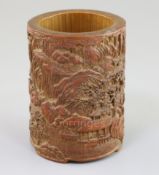 A Chinese bamboo brush pot, carved in high relief and openwork with figures and pavilions in a
