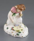 A Rockingham porcelain group of a kneeling girl playing with a kitten, c.1830, impressed mark '
