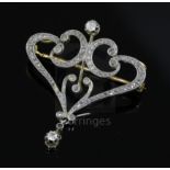 A French Belle Epoque 18ct gold and diamond set openwork scroll drop pendant brooch, 38mm.