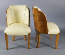 A set of six Art Deco tiger maple cloud back dining chairs, with cream leather upholstery on