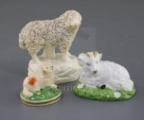 Three Rockingham porcelain figures of sheep, c.1830, the smallest of a lamb painted in colours,