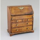 A mid 18th century style miniature walnut bureau, with fitted interior, well and four drawers, 9in.,