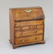 A mid 18th century style miniature walnut bureau, with fitted interior, well and four drawers, 9in.,
