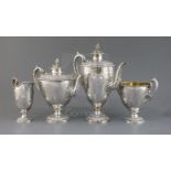 An ornate Victorian silver pedestal four piece tea and coffee service by Martin, Hall & Co, of