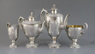 An ornate Victorian silver pedestal four piece tea and coffee service by Martin, Hall & Co, of