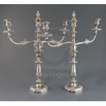 A pair of 19th century Sheffield plate two branch three light candelabra, with engraved crest, 52.