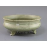 A Chinese Ming Longquan celadon tripod censer, 16th century, the exterior incised with foliage, on