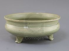 A Chinese Ming Longquan celadon tripod censer, 16th century, the exterior incised with foliage, on