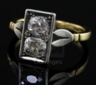 An 18ct gold, platinum and two stone diamond rectangular tablet ring, set with two old cut stones,