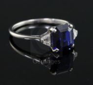 A 1940's? platinum, sapphire and diamond three stone ring, the central emerald cut sapphire