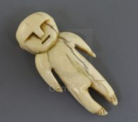 A Tongan or Fijian whale tooth pendant, carved in the form of a human, H. 5.5cmcf. a whale ivory