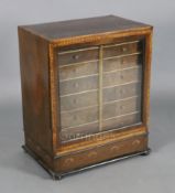 A George III mahogany and yew wood table cabinet, the top and sides inlaid with oval panels within