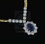 An 18ct two colour gold, sapphire and diamond oval cluster pendant necklace, 42cm