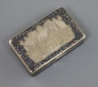A 19th century Russian 84 zolotnik silver and niello work snuff box, decorated with a view of the