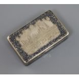 A 19th century Russian 84 zolotnik silver and niello work snuff box, decorated with a view of the