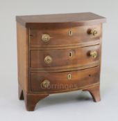 A Regency mahogany miniature bowfront chest, fitted three drawers, 7.25in., height 7.5in.