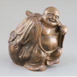 A Japanese Bizen ware figure of Hotei, Meiji period, with pierced bag to his back for burning