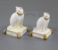 Two Rockingham porcelain figures of a cat seated on a tasselled cushion, c.1830, both decorated in