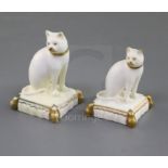 Two Rockingham porcelain figures of a cat seated on a tasselled cushion, c.1830, both decorated in